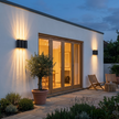 A pair of Verano wall lights on a garden terrace