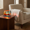 Novella book lamp lit on a walnut side table