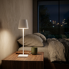 Halden lamp lit on a bedside table at night