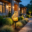 Wynn solar light glowing in a planted border at dusk